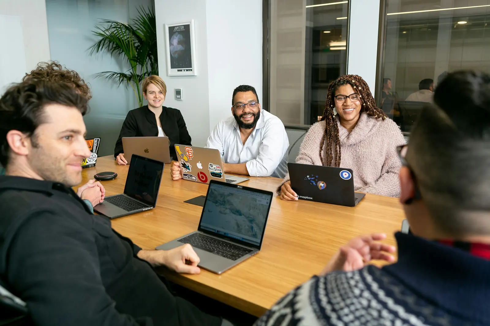 A small team working on laptops around a table