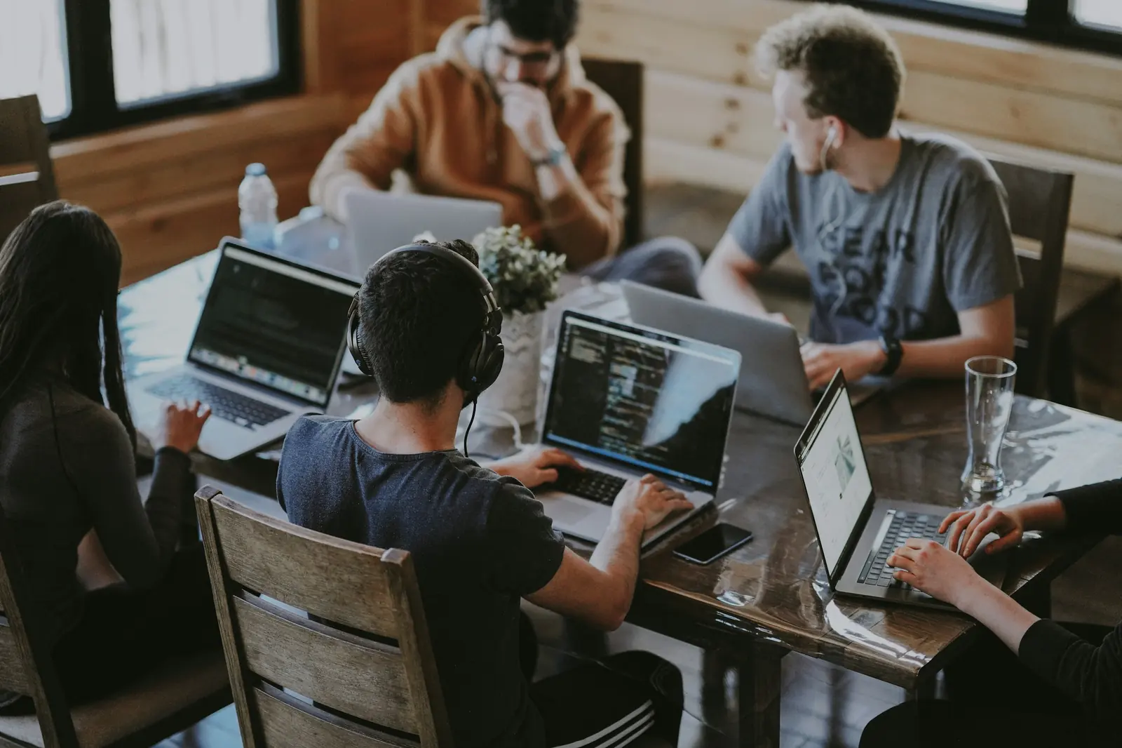 People working on laptops at a shared table