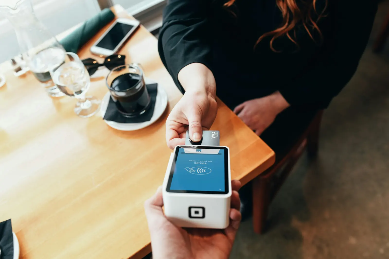 A card payment at a café table